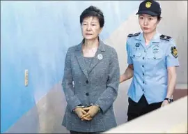  ?? Kim Hong-Ji Pool Photo ?? PARK GEUN-HYE is shown being escorted to a court appearance in August 2017. She refused to participat­e in her defense during a yearlong trial.