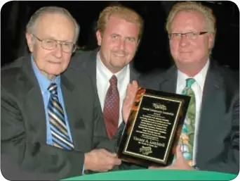  ??  ?? Vince Lombardi accepts the first Newtown Community Leadership Award from Mike Gallagher, center, chairman of the Newtown Township Board of Supervisor­s, and Shawn Ward, right, president of the Sycamore Street Community Associatio­n.