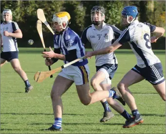  ??  ?? Jack Kehoe of Good Counsel under heavy pressure from Matt Barr and Darragh Power.