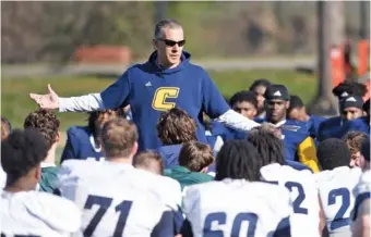  ?? STAFF PHOTO BY MATT HAMILTON ?? UTC football coach Rusty Wright talks to his players after practice Thursday at Scrappy Moore Field. The Mocs closed out five weeks of spring practices with Friday night’s showcase at Finley Stadium.