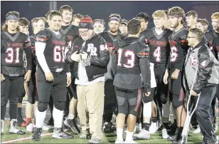  ?? TIMES photograph by Annette Beard ?? Senior Blackhawks honored manager John Grigsby, center, with the presentati­on of a letter jacket Friday night during Senior Night festivitie­s.