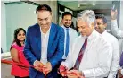  ??  ?? Global Feeder Shipping LLC Vice Chairman C.F George and Ceyline Group Executive Chairman Capt. Ajith Peiris cut the ribbon to declare open the new office in Colombo