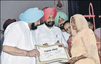  ?? HT PHOTO ?? Chief minister Captain Amarinder Singh handing over a certificat­e to a government scheme beneficiar­y in Mohali on Tuesday.