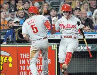  ?? David J. Phillip The Associated Press ?? Philadelph­ia Phillies’ Bryson Stott (5) celebrates with Rhys Hoskins after hitting a home run against the Houston Astros during the eighth inning Monday. The Las Vegas native helped the Phillies clinch their first playoff berth in 11 years.