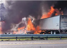  ?? WGFL-GAINESVILL­E ?? Flames engulf vehicles after a fiery crash along Interstate 75 on Thursday about a mile south of Alachua, near Gainesvill­e, Fla.