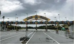  ?? JOE BURBANK/ORLANDO SENTINEL ?? The first effects of Hurricane Ian are seen over the entrance to the Magic Kingdom on Sept. 28. Theme parks closed, but hotel-tax collection­s rose.