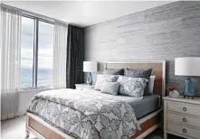  ??  ?? The primary bedroom’s blue palette includes John Robshaw block-print bedding, darker draperies and grasscloth wallcoveri­ng.