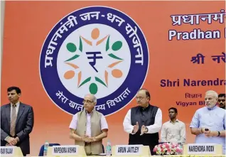  ?? — AP ?? Prime Minister Narendra Modi launches the Pradhan Mantri Jan Dhan Yojana in 2014 in the presence of finance minister Arun Jaitley, principal secretary to the Prime Minister Nripendra Misra and then RBI governor Raghuram Rajan.