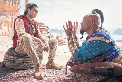  ?? DANIEL SMITH DISNEY VIA THE ASSOCIATED PRESS ?? Will Smith makes the role of the genie his own in a smartass performanc­e while Mena Massoud checks most of the boxes as the lead in Aladdin, Ryan Porter writes.