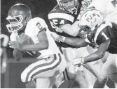  ?? JONWAY/ CORRESPOND­ENT PHOTO ?? Pine Crest’s Dominic Pollmeni, left, runs with the ball as Pope John Paul’s DeQuan McGriff goes for the tackle in the second quarter Thursday.