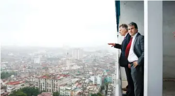  ??  ?? McAuliffe, left, takes in the view from the 22nd-floor suite of the Havana Libre Hotel, which was Fidel Castro’s office.