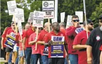  ?? CARLOS OSORIO AP ?? United Auto Workers march outside the Stellantis North American Headquarte­rs in Auburn Hills, Mich., on Wednesday.