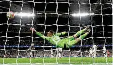 ?? PHOTO: REUTERS ?? Manchester City’s Josko Gvardiol scores their third goal passed Real Madrid’s Andriy Lunin.