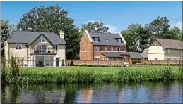  ??  ?? ‘GENERIC’: The Cotswolds houses by a lake used on the Finco website