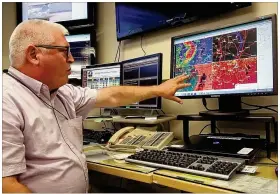  ?? TY GREENLEES PHOTOS / STAFF ?? Philip Studler, a meteorolog­ist with the 88th Operations Support Squadron Base Weather Office at Wright-Patterson Air Force Base, shows high-resolution radar that assists in locating potential tornadoes.