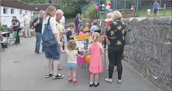  ?? 01_B24WB15 ?? Visitors have a go at winning fun prizes at the tombola.