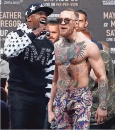  ?? NOAH K. MURRAY, USA TODAY SPORTS ?? Floyd Mayweather Jr., left, and Conor McGregor will face off in a boxing ring Aug. 26 in Las Vegas.