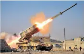  ??  ?? An Iraqi army rocket heads towards Isil positions south of Mosul; right, the battle for the airport