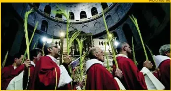  ?? PHOTO: REUTERS ?? Catholic clergy carry palm fronds during the Palm Sunday procession in the Church of the Holy Sepulchre in Jerusalem this week