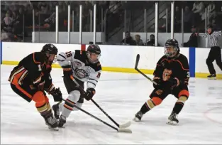  ?? NEWS PHOTO JAMES TUBB ?? Medicine Hat Cubs forward Darnell Glasgo splits a pair of Coaldale defenceman in the third period of a Game 2 4-3 2OT win Sunday on the road over the Copperhead­s.