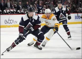  ?? DAVID ZALUBOWSKI — THE ASSOCIATED PRESS ?? Avalanche defenseman Cale Makar, front, clears the puck as Nashville Predators center Ryan Johansen defends last season in Denver.