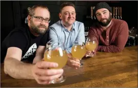  ?? The Canadian Press ?? From left, Barn Hammer Brewing Company head brewer Brian Westcott, University of Winnipeg associate professor and chair of classics Matt Gibbs, and Barn Hammer Brewing Company owner Tyler Birch pose for a photo after they teamed up to recreate an...