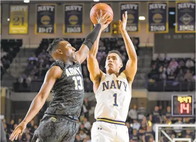  ?? PHOTOS BY TERRANCE WILLIAMS/CAPITAL GAZETTE ?? Navy Midshipmen guard John Carter Jr. (1) has shot blocked by Army Black Knights guard Lonnie Grayson (13) during the first half at Navy Alumni Hall in Annapolis.