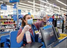  ?? COURTESY PHOTO ?? A Walmart employee cleans a plastic barrier during the novel coronaviru­s pandemic. Editor’s note: This photo was not taken at the Walmart in Taos.