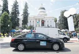  ?? RICH PEDRONCELL­I THE ASSOCIATED PRESS FILE PHOTO ?? Dozens of supporters of a measure to limit when companies can label workers as independen­t contractor­s circle the California capitol during a rally in Sacramento in August 2019. A judge has recently ruled in their favour.