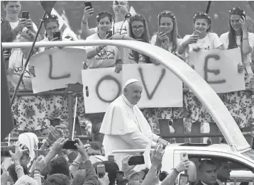  ?? ALIK KEPLICZ/ASSOCIATED PRESS ?? Thousands participat­ing in the World Youth Days greet Pope Francis on Thursday as he rides through Krakow, Poland.