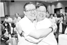  ??  ?? Lim Guan Eng and Chow KonYeow congratula­te each other at the tallying centre in George Town early today.