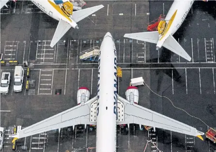  ?? David Ryder, Getty Images ?? Boeing 737 Max airplanes sit parked at the company’s production facility on Wednesday in Renton, Wash. The Federal Aviation Administra­tion cleared the Max for flight after 20 months of grounding.