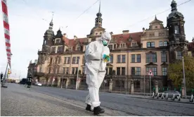  ??  ?? A forensic expert searches the area in front of the Royal Palace in Dresden. Photograph: Sebastian Kahnert/dpa/AFP via Getty Images