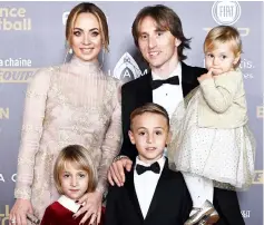  ?? — AFP photo ?? Luka Modric (centre) and his family pose upon arrival at the FIFA Ballon d’Or award ceremony at the Grand Palais in Paris.