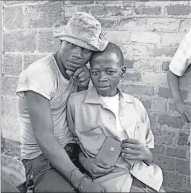  ??  ?? Young men with dompas (an identity document every African had to carry) , White City, Jabavu , Soweto, 1972