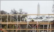  ?? THE ASSOCIATED PRESS ?? Constructi­on continues on the presidenti­al reviewing stand on Pennsylvan­ia Avenue in Washington, looking toward the White House and the Washington Monument.