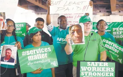  ?? KIM HAIRSTON/BALTIMORE SUN ?? Patrick Moran, AFSCME Maryland Council 3 president, holds a photo in 2019 of a worker who he says was injured at the Potomac Center in Hagerstown. On Friday, the union announced it had failed to reach an agreement with the state for the first time in more than 10 years.