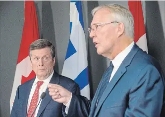  ?? CHRIS YOUNG THE CANADIAN PRESS ?? Bill Blair, right, federal minister of border security, and Mayor John Tory in Toronto Friday. Toronto now has $11 million from Ottawa to help defray pay some costs incurred in dealing with an influx of border crossers.