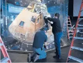  ?? JAY REEVES/AP ?? The Apollo 16 lunar capsule in encased in glass at the U.S. Space and Rocket Center in Huntsville, Ala.