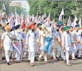  ?? ANI AFP ?? Farmers shout slogans as they carry out a march against the new farm bills, on the outskirts of Amritsar on Sunday.