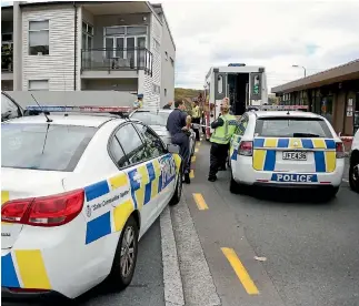  ?? PHOTO: CAMERON BURNELL/FAIRFAX NZ ?? Police at the scene in Mana, Porirua, where a man was fatally shot by an officer yesterday.