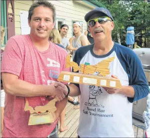  ?? EVAN CERETTI/THE GUARDIAN ?? Chad Ceretti, left, winner of the Caseys’ 30th annual Sand Bar Golf Tournament, accepts his trophy from event ogranizer Ron Casey. The event ran Saturday in Seven Mile Bay.