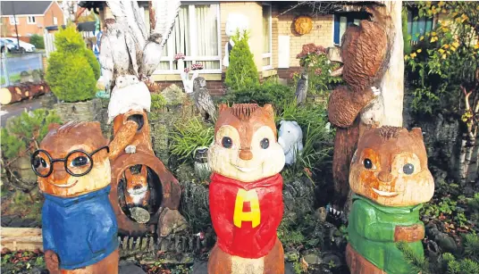  ??  ?? Some of Christophe­r Bowman’s creations in his Gleneagles Avenue garden. Above: three chipmunks and right: woodland animals.