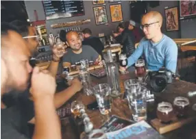  ?? Photos by RJ Sangosti, The Denver Post ?? Customers sample beer Thursday at Black Shirt Brewing, which is getting ready to celebrate the brewery’s fifth anniversar­y.