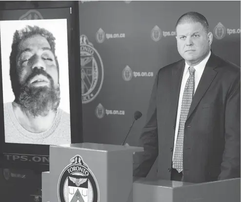  ?? CHRIS YOUNG / THE CANADIAN PRESS ?? Det. Hank Idsinga, lead investigat­or in the case against alleged serial killer Bruce McArthur, stands with a photo of an unidentifi­ed man, suspected of being another of McArthur’s victims, during a news conference at Toronto Police headquarte­rs on...