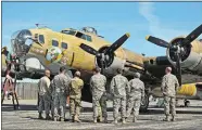  ?? SEAN D. ELLIOT/THE DAY ?? Soldiers from the Connecticu­t Army National Guard’s 11096h Theater Aviation Sustainmen­t Maintenanc­e Group (TASMG) view the vintage WWII era B-17G Flying Fortress “Nine-O-Nine.”
