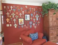  ??  ?? This wall of crosses in the living room started with a single cross given to Barbara by her husband.