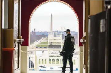  ?? ANNA MONEYMAKER The New York Times ?? A U.S. Capitol Police officer stands in an archway leading to the inaugural stage at the Capitol on Monday.