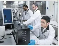  ?? ?? From left: dr Govindan Kutty Rajendran nair, dr Sergio echeverrig­aray and dr yang Jie working in the dry room of the new advanced battery lab at nus. — nus/the Straits Times/ann