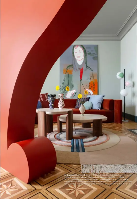  ??  ?? Living room Christophe Delcourt’s ‘Eko’ sofa is placed beneath a painting by Françoise Pétrovitch in this joyful space. The floor lamp is from the Magic Circus Éditions’ ‘Pop-Up’ range and the rug is ‘Bliss Ultimate’ by Mae Engelgeer for CC-Tapis. Playful vases by Victor Alarçon and Nitsa Meletopoul­os from Galerie Tatiss sit on the ‘Lob’ coffee tables, a walnut and travertine design by Christophe Delcourt for Collection Particuliè­re